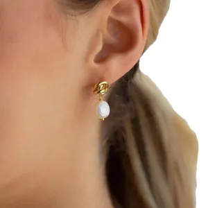 Elegant 18K gold plated titanium steel pearl drop earrings worn by a model for daily style