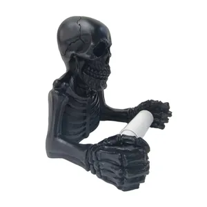 Side detail of a gothic black resin skeleton toilet paper holder for Halloween decor