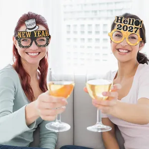 Lifestyle shot of people wearing gold and black glittery New Year party glasses
