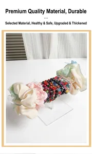 Transparent acrylic T-bar display stand holding scrunchies and beaded jewelry bracelets