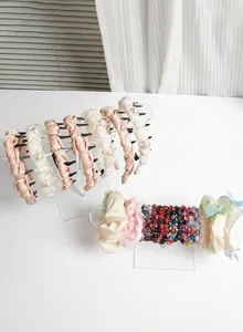 Detail of transparent acrylic headband and jewelry display stand with hair accessories