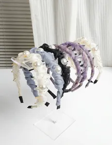 Clear acrylic headband display stand showing multiple hair accessories in detail