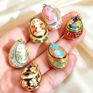 Detailed view of hand-painted colorful enamel floral egg charms for jewelry making