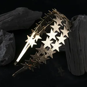 Detail of a shiny gold double-layer star headband on a dark backdrop