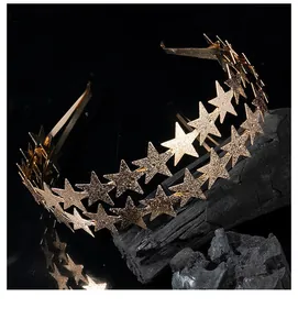 Close-up detail of a double-layered golden star headband on a black textured background