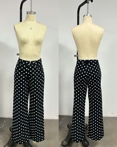 Front and back detail view of black polka dot wide-leg denim pants on a mannequin.