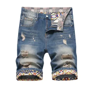 Trendy slim straight distressed ripped men's denim shorts with colorful patterned lining