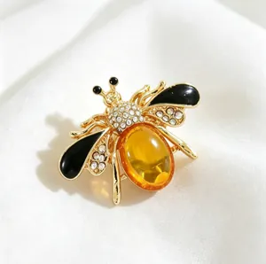 Elegant honeybee brooch featuring a large yellow stone and sparkling rhinestones.