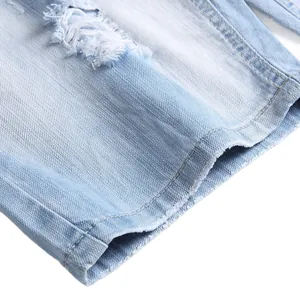 Close-up detail of light blue ripped denim shorts for men in casual summer style