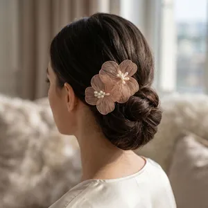 Elegant gold wire mesh flower hair comb with white pearls styled on a bridal bun.