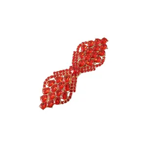 Detail of elegant red crystal rhinestone spring hair clip with gold-tone base