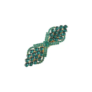 Detailed view of elegant green teardrop crystal hair clip with sparkling golden base