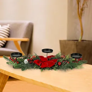 Detailed view of Christmas centerpiece featuring pine needles, red berries, and bow