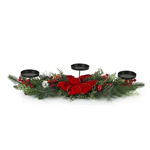 Detail of Christmas centerpiece with 3 candle holders, red bow, and pine needles