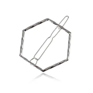 Detailed macro view of a silver twisted hexagonal geometric minimalist metal hair clip