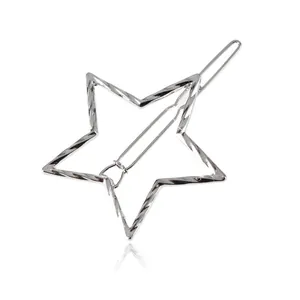 Detail shot of a minimalist silver star-shaped hair clip with twisted metal texture.