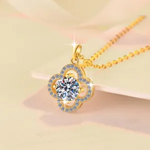 Macro view of gold-plated clover pendant with sparkling 1 carat moissanite center stone
