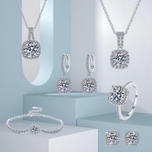Elegant jewelry display showing silver moissanite necklace and ring on blue podiums