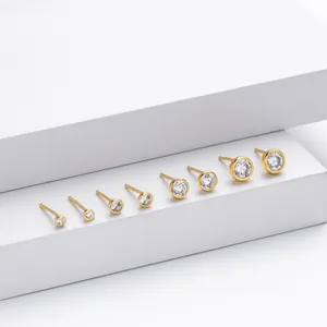 Collection of gold-plated silver stud earrings in seven different sizes