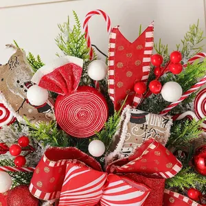 Festive Christmas hanging wreath featuring candy canes red ribbons and faux pine needles