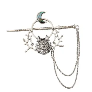 Detailed view of vintage silver wolf and moon hair pin with abalone inlay and chain