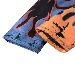 Detail view of men's slim black denim pants with vibrant flame print and street style