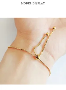 Detailed macro view of adjustable gold titanium steel sliding bolo bracelet on a wrist