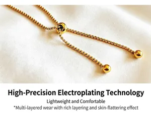 High detail of an adjustable gold box chain bracelet with a sliding toggle mechanism