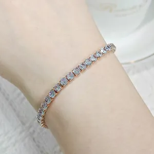 Close-up of an elegant rose gold tennis bracelet with sparkling clear zircons on a wrist