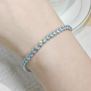 Close-up of an elegant tennis bracelet with sparkling cubic zirconia on a wrist.
