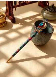 Detail of vintage peacock hair stick with imitation cloisonné and blue gemstone