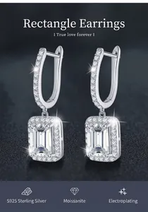 Detailed macro view of 925 sterling silver moissanite earrings with emerald cut stones.