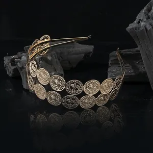 Detailed view of the double-layered gold metal headband with embossed coin accents