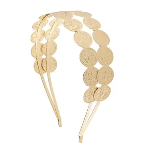 Detailed view of the double-layered golden metal headband with coin accents.