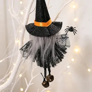Detail view of a Halloween witch hanging ornament with black lace skirt and bells