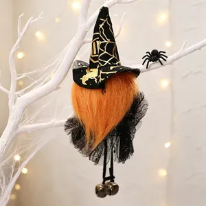 Macro detail of Halloween witch gnome hanging ornament with bells and lace skirt