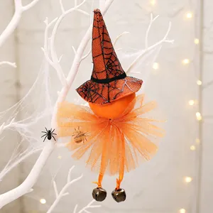 Close-up detail of a Halloween witch pumpkin hanging ornament with orange tutu and bells
