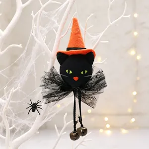 Detailed view of Halloween black cat ornament with orange witch hat and bells.