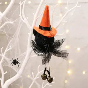 Halloween witch hanging ornament with orange hat, mesh skirt and bells detail.