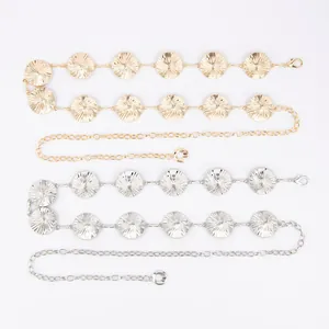 Detail of gold and silver bohemian waist chains with textured sunburst metal discs