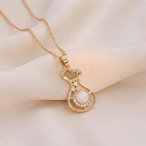 Elegant gold-tone lucky bag pendant necklace featuring a cat-eye stone and zircons.