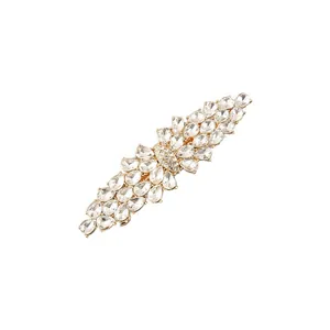 Detailed view of a gold-toned hair clip featuring shimmering teardrop zircon stones.