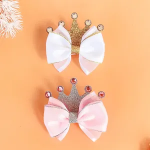 Detail of glitter crown bow hair clips for girls in elegant white and pink satin finish