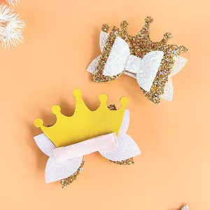 Detailed macro view of glitter princess crown hair clips with bow and alligator clip.