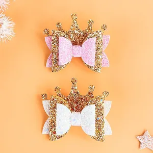 Detailed view of shimmering pink and white glitter crown bow hair clips for little girls
