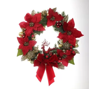Detailed view of a festive Christmas wreath with red flowers and gold ornaments