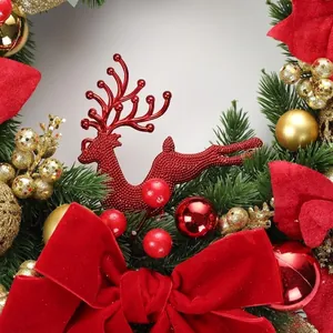 Detailed close-up of a festive Christmas wreath with red velvet bows and reindeer ornaments