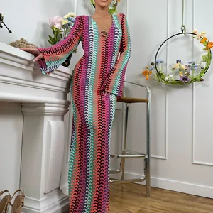 Detailed view of the vibrant wave-patterned V-neck maxi dress with long sleeves.