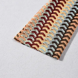 Detailed view of multicolored wavy crochet knit fabric texture on long sleeve dress