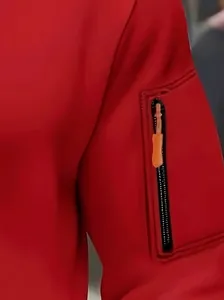 Close-up of red men's hoodie sleeve featuring a zipper pocket with orange pull tab.